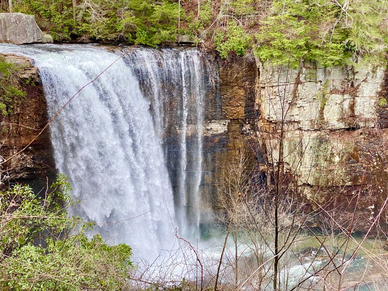 Wide waterfall over layered sandstone