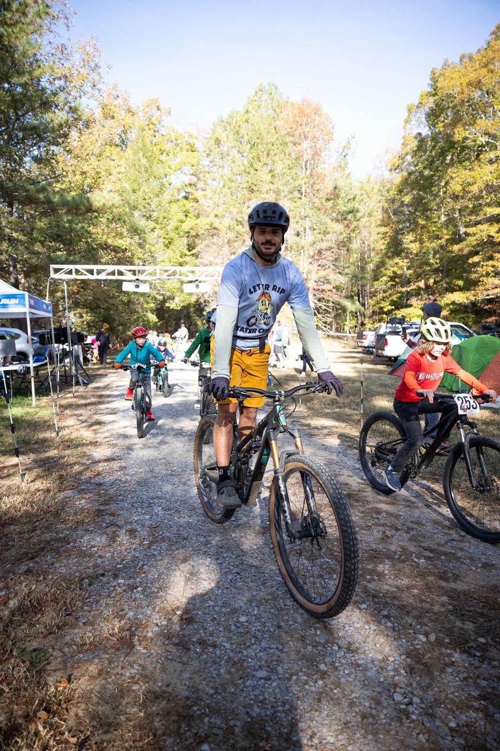 A rider finishing under the race arch