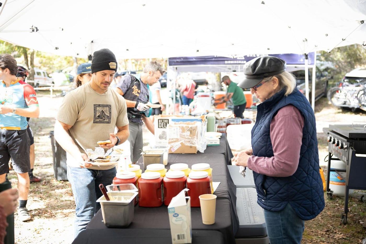Volunteers serving food at the race tent